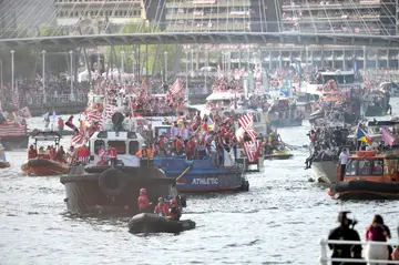 Athletic Bilbao players sail on board the famous "Gabarra" boat (C) under the Zubizuri bridge to celebrate the Copa win