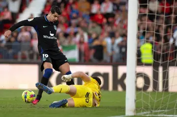 Atletico Madrid forward Alvaro Morata (L) challenges Almeria's goalkeeper Fernando Martinez in the 1-1 draw
