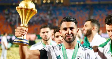 Riyad Mahrez celebrates with the FCON trophy during the award ceremony after Algeria defeated Senegal in the 2019 Africa Cup of Nations final (Photo by Islam Safwat/NurPhoto via Getty Images)