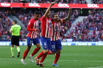 Atletico Madrid striker Angel Correa (R) celebrates scoring his team's fourth goal in the rout of Las Palmas