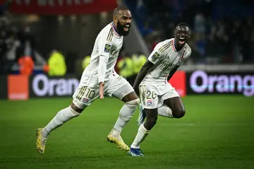 Alexandre Lacazette (L) celebrates after scoring against Toulouse