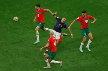 France superstar Kylian Mbappe (C) is surrounded by Moroccans during a 2022 World Cup semi-final in Qatar