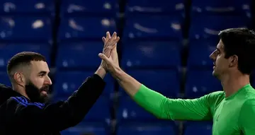 Karim Benzema and  Thibaut Courtois celebrate a quarter-final victory at Chelsea as Real Madrid marched toward the Champions League