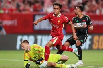 Liverpool midfielder Fabio Carvalho, center, scores past Arsenal goalkeeper Karl Hein in a 2-1 triumph in a pre-season friendly at Philadelphia