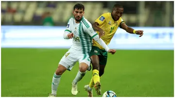 South Africa's Elias Mokwana (right) vies for the ball with Algeria's Houssem Aouar during an international friendly match in Algiers, Algeria, on March 26, 2024. Photo: Richard Pelham.