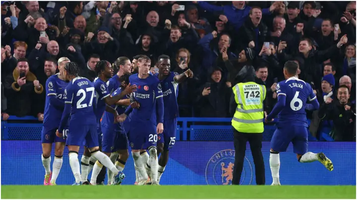 Cole Palmer celebrates with teammates after scoring his team's fourth goal during the Premier League match between Chelsea FC and Manchester City. Photo by Clive Rose.