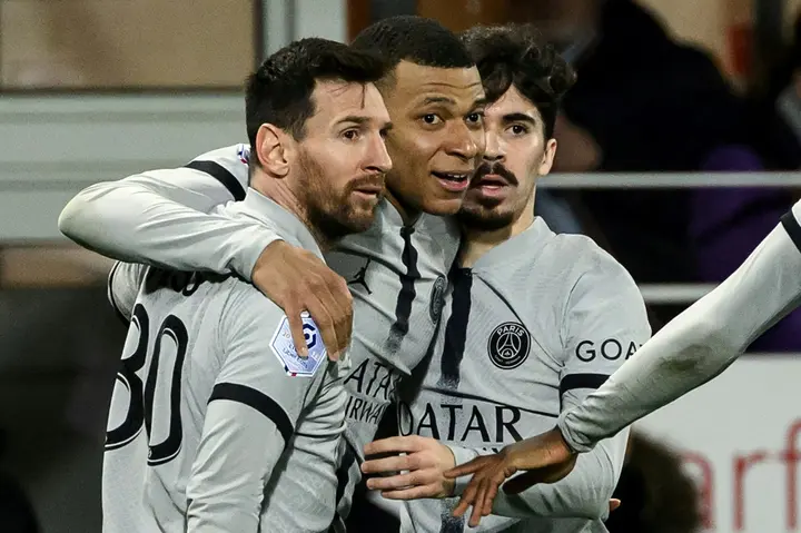 Kylian Mbappe (C) celebrates with Lionel Messi and Vitinha after scoring PSG's late winning goal against Brest in Ligue 1 on Saturday