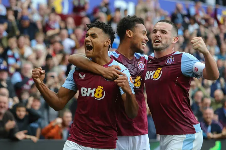 Aston Villa striker Ollie Watkins (L) celebrates scoring against Brighton