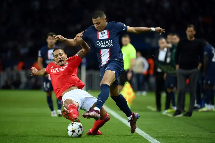 Paris Saint-Germain star Kylian Mbappe (r), trying to elude  Benfica's Gilberto Moraes Junior, was the focus of attention on and off the field