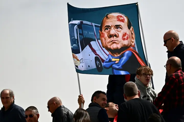 Monza supporters display a banner with a caricature of Silvio Berlusconi. Berlusconi bought Monza after selling AC Milan and helped the modest club reach Italy's top division