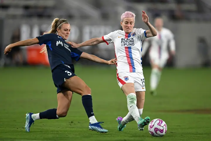 OL Reign midfielder Megan Rapinoe fights for the ball with San Diego Wave's Rachel Hill in the Reign's victory in their National Women's Soccer League semi-final