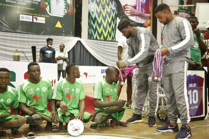 Peter Okoye presents medals to winners at the Girls and Para Soccer Championship