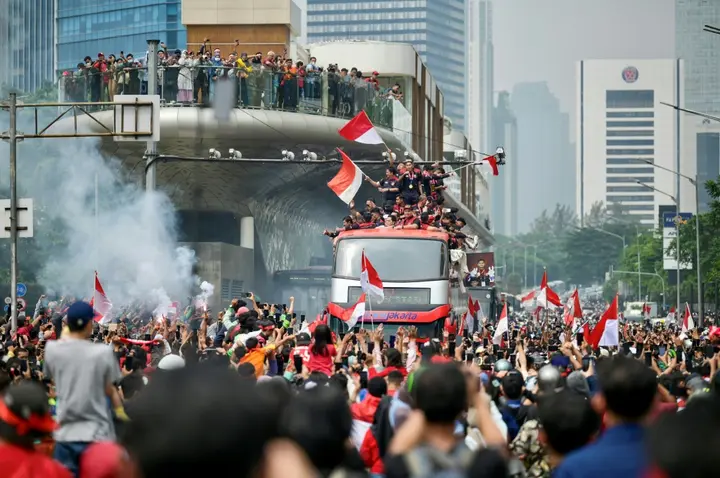 Fans attend a victory parade for Indonesia's football team in Jakarta