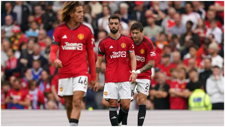 Bruno Fernandes and team-mates appear dejected after Brighton's third goal during their Premier League match at Old Trafford. Photo by Martin Rickett.