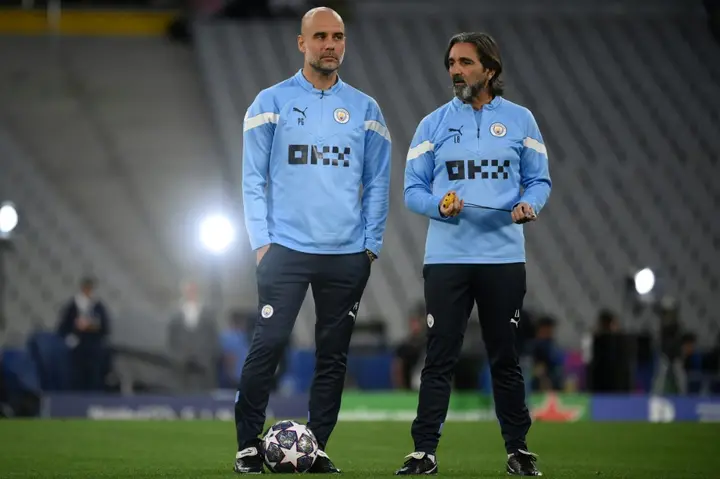 Pep Guardiola (L) alongside Manchester City's Spanish fitness coach Lorenzo Buenaventura as their team train at the Ataturk Olympic Stadium in Istanbul on Friday