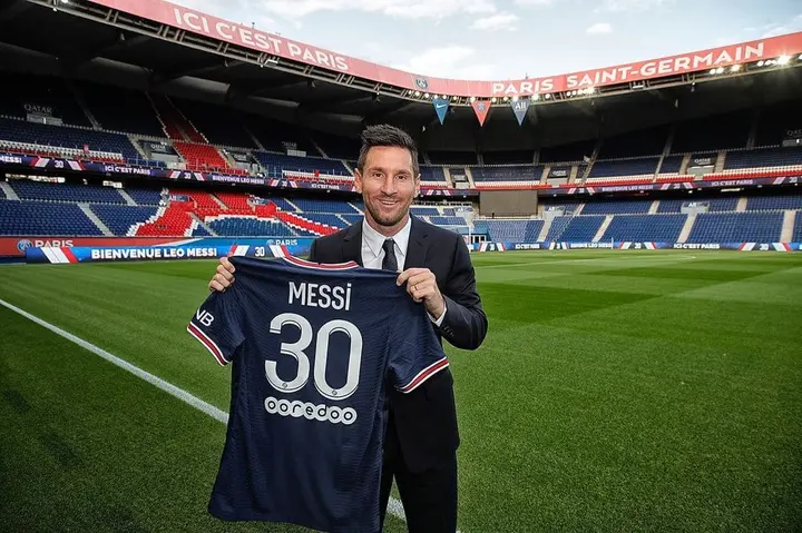 Paris, France. 11th Aug, 2021. A supporter shows a jersey of PSG's  Argentinian football player Lionel Messi, that he has just bought at the  Paris-Saint-Germain (PSG) football club store on the Champs