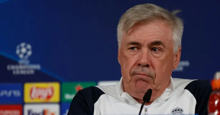 Carlo Ancelotti looking annoyed during a press conference.