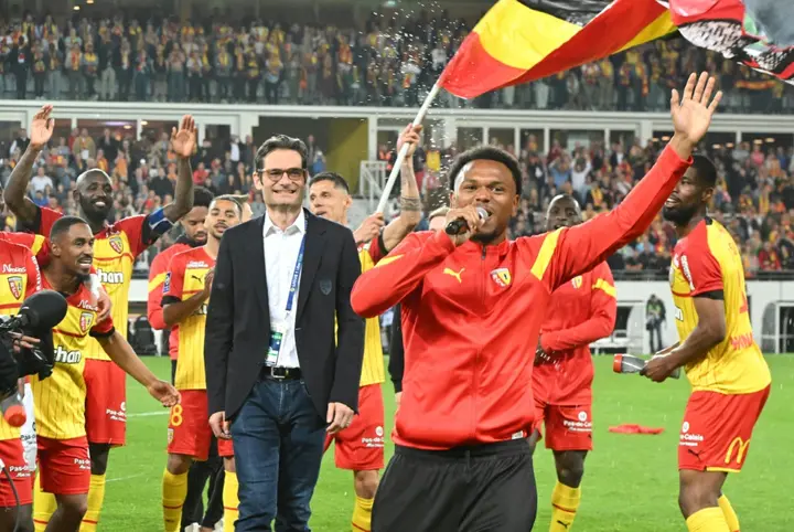 Lens players celebrate after they defeated Ajaccio to secure second place and a Champions League berth for next season