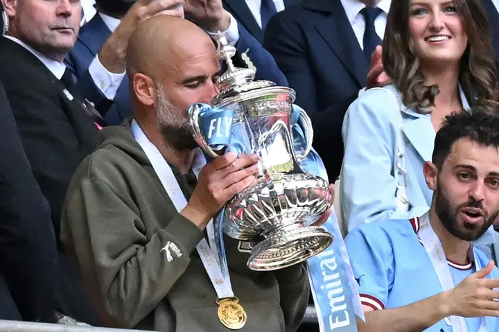 Manchester City boss Pep Guardiola holding the FA Cup after his team beat Manchester United in last week's final
