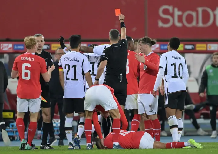 Slovenian referee Slavko Vincic shows a red card to Germany forward Leroy Sane in Tuesday's Germany vs Austria match in Vienna