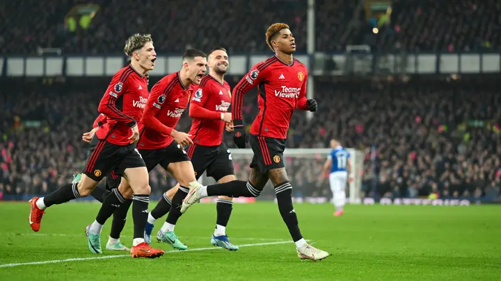 Marcus Rashford celebrates with teammates after scoring during the Premier League match between Everton FC and Manchester United at Goodison Park. Photo by Michael Regan.