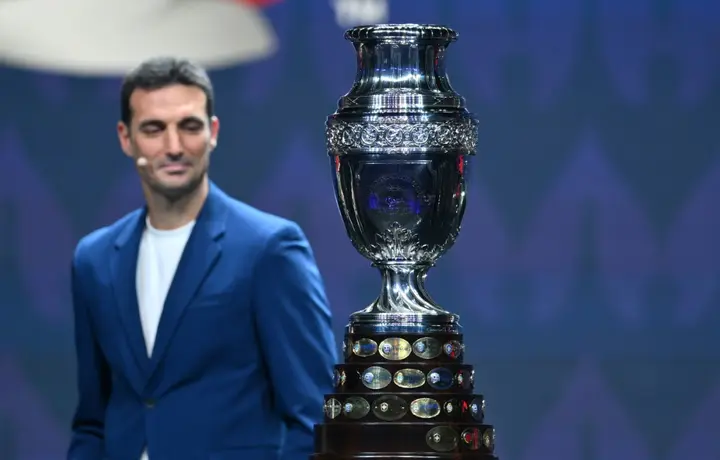 Argentina coach Lionel Scaloni eyes the Copa America trophy during the final draw for the 2024 tournament in Miami on Thursday