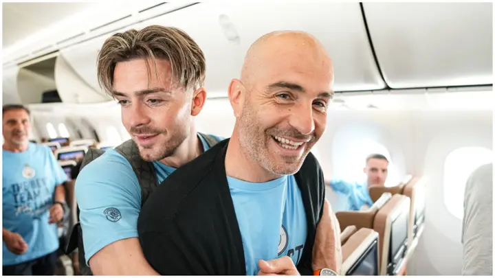 Manchester City's Jack Grealish and Enzo Maresca on the plane back to Manchester with the UEFA Champions League trophy. Photo by Tom Flathers.