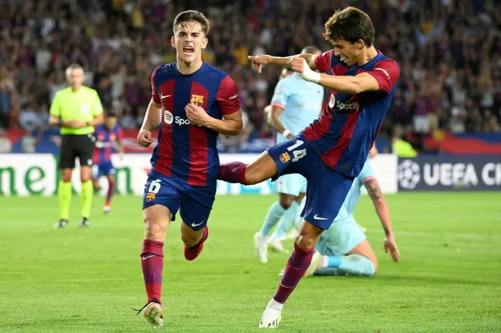 Goalscorers Joao Felix (R) and Gavi (L) celebrate during Barcelona's heavy win over Royal Antwerp