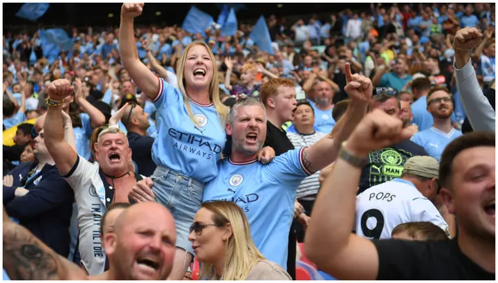Manchester City fans celebrate their second goal during the FA Cup final against Manchester United at Wembley Stadium. Photo by Michael Regan.