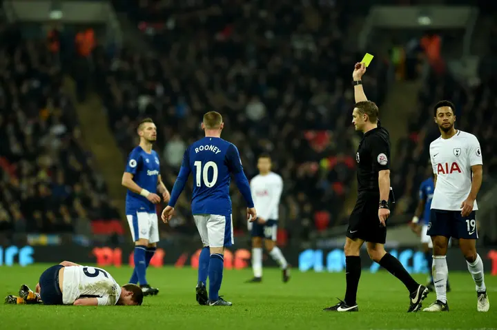 Wayne Rooney (10) receives a yellow card after a foul during a Premier League football match
