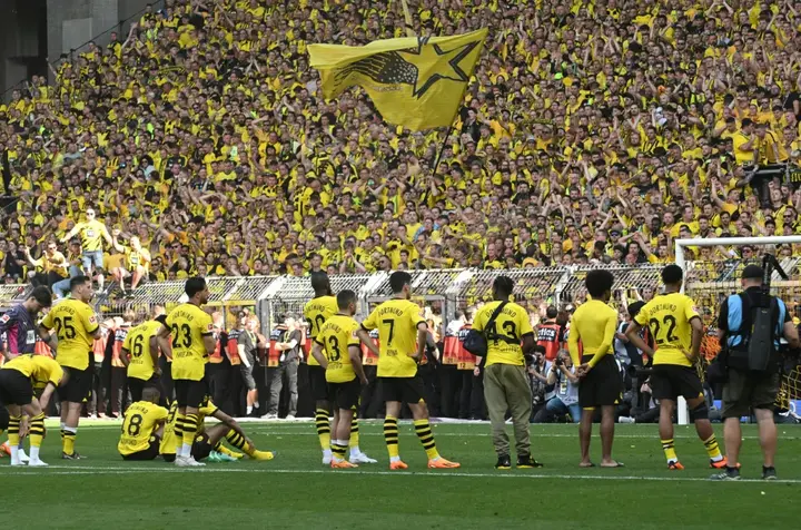 Dortmund players in front of the club's yellow wall after their 2-2 draw with Mainz