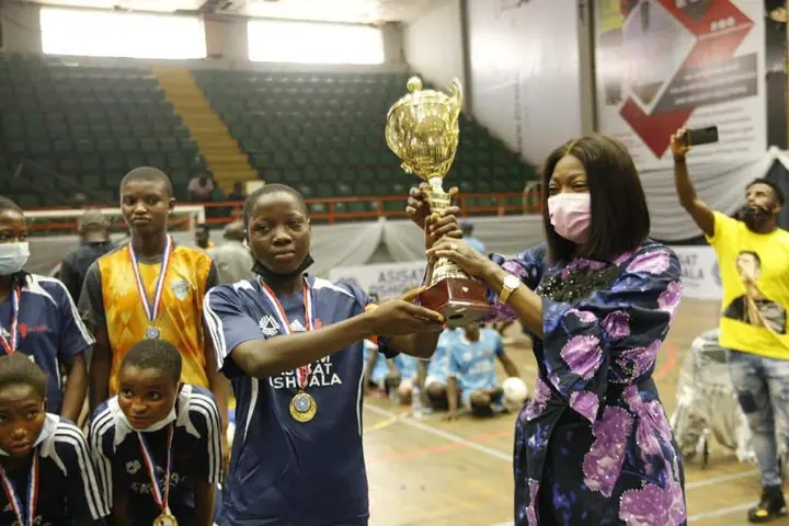 Mrs Ambode presents the cup to winners at the Girls and Para Soccer Championship
