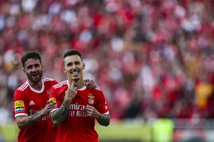 Benfica's Spanish full-back Alex Grimaldo (R) celebrates with Rafa Silva after scoring a penalty to help his team win the title
