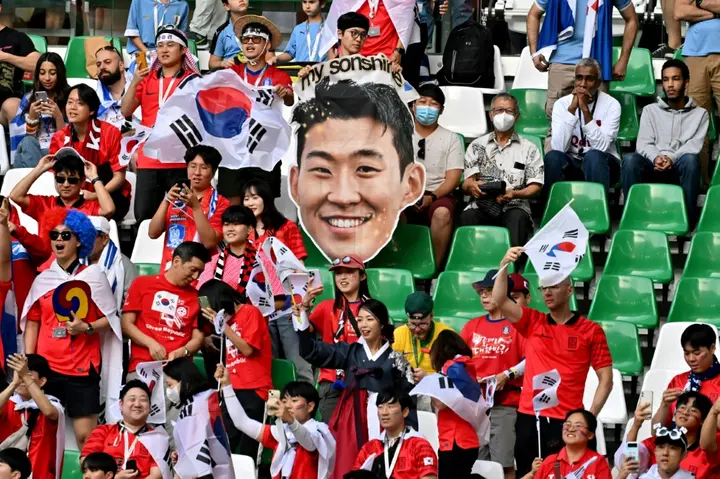 A South Korea supporter holds a cutout picture of their hero Son Heung-min