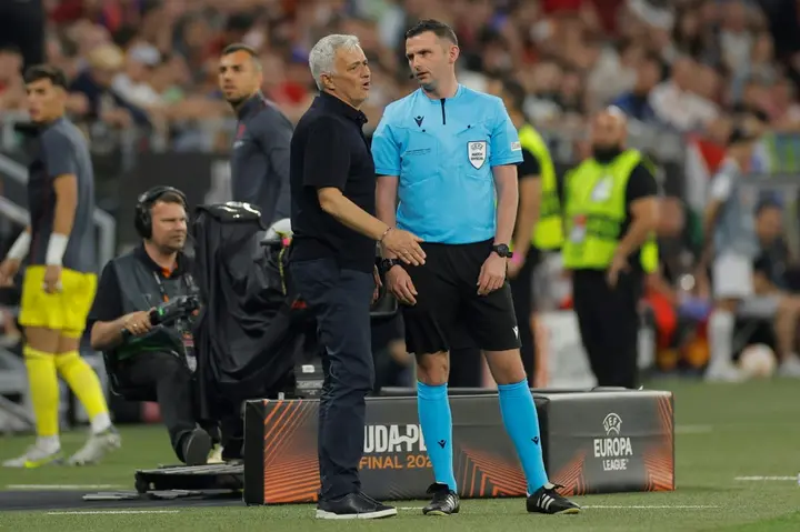 AS Roma coach Jose Mourinho remonstrates with fourth official Michael Oliver during the  Europa League final