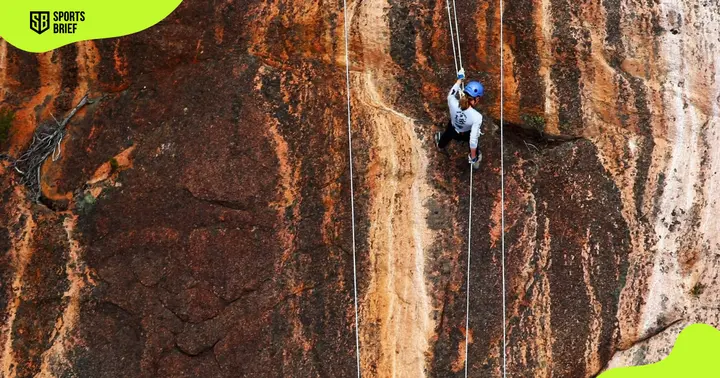 Elina Ussher pictured abseiling a rock wall in Tasmania, Australia.