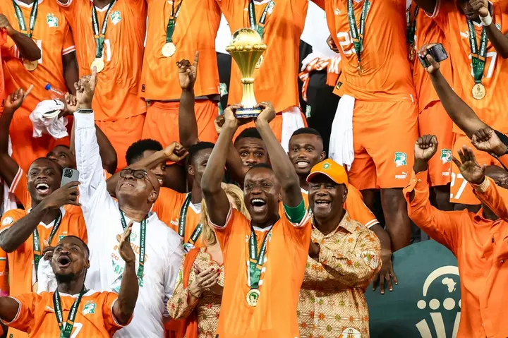 Ivory Coast's Max-Alain Gradel lifts the Africa Cup of Nations trophy aloft after Sunday's final victory against Nigeria