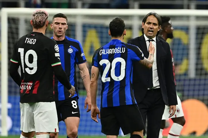 Inter coach Simone Inzaghi (R) congratulates Turkish midfielder Hakan Calhanoglu after the semi-final win over AC Milan