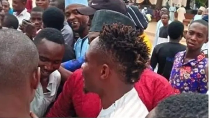 Football fans surround Ahmed Musa in a mosque in Abuja