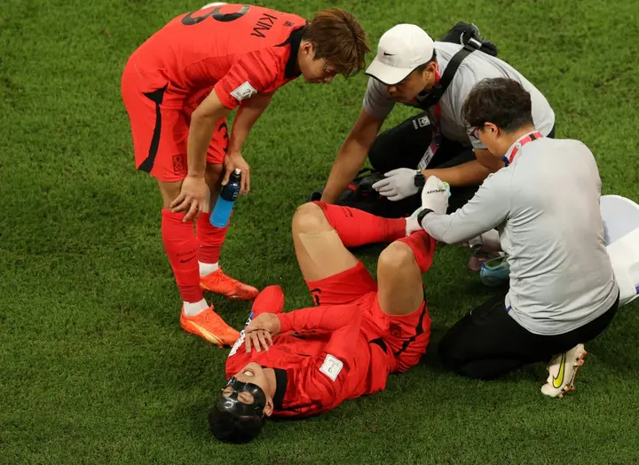 South Korea's Son Heung-min receives medical treatment after being on the end of a nasty Uruguay challenge