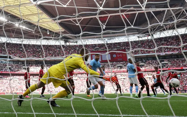 Manchester City's Ilkay Gundogan beats Manchester United goalkeeper David de Gea in the FA Cup final at Wembley