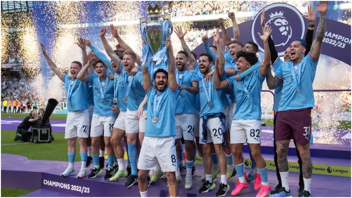 Manchester City captain Ilkay Gundogan lifts the Premier League trophy in front of his teammates at Etihad Stadium. Photo by Visionhaus.