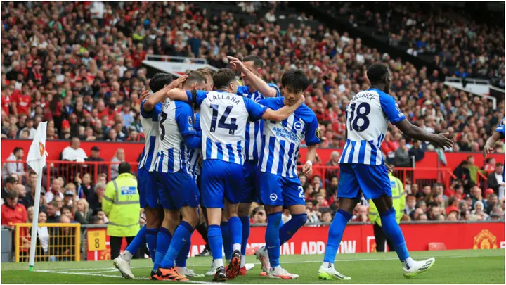 Kaoru Mitoma joins teammates as they celebrate during the Premier League match between Manchester United and Brighton at Old Trafford. Photo by Simon Stacpoole.